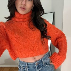 Bright orange cropped turtleneck sweater